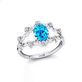 Flower Inspired Ring with Oval Shaped Swiss Blue Topaz and Accent Diamonds