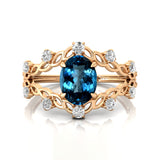 Flower Inspired Ring with Oval Shaped London Blue Topaz and Accent Diamonds