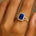 Halo Set Emerald Shaped Blue Sapphire Split Shank Ring with Accent Diamonds - GeumJewels
