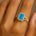 Halo Set Emerald Shaped Swiss Blue Topaz Split Shank Ring with Accent Diamonds - GeumJewels