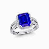 Halo Set Emerald Shaped Tanzanite Split Shank Ring with Accent Diamonds